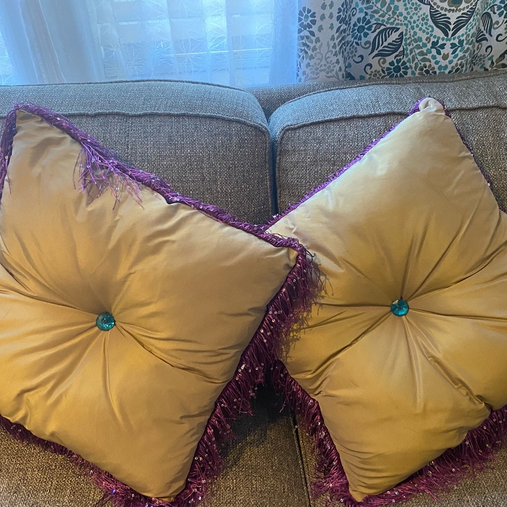 2 gold satin pillows